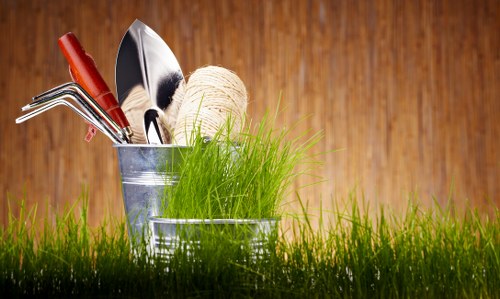 Landscape gardeners experiencing physical strain from mowing.